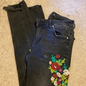 Distressed black jeans with floral detailing